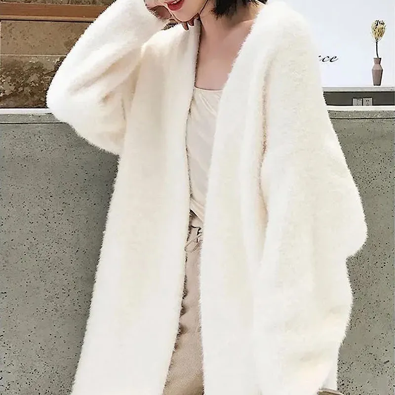 Luxury white long cashmere cardigan demonstrating advanced layering techniques